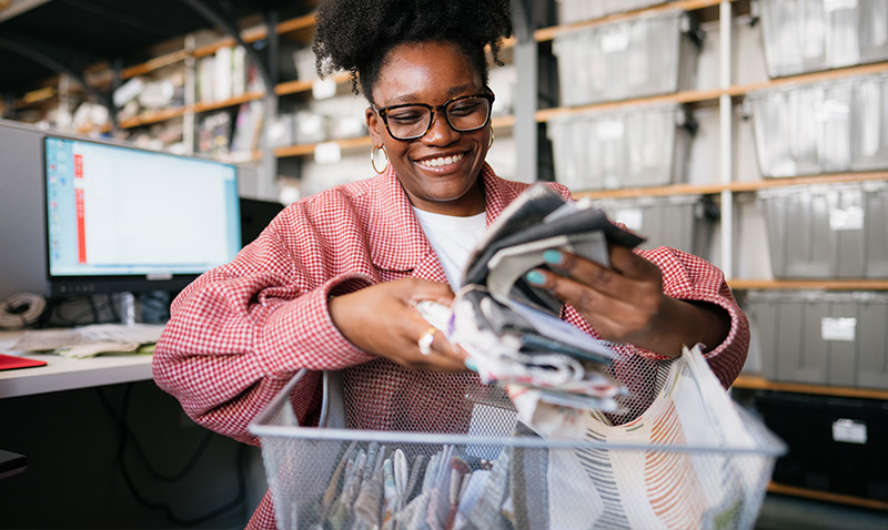 A NYSID Student sorts through fabric samples in the design studio