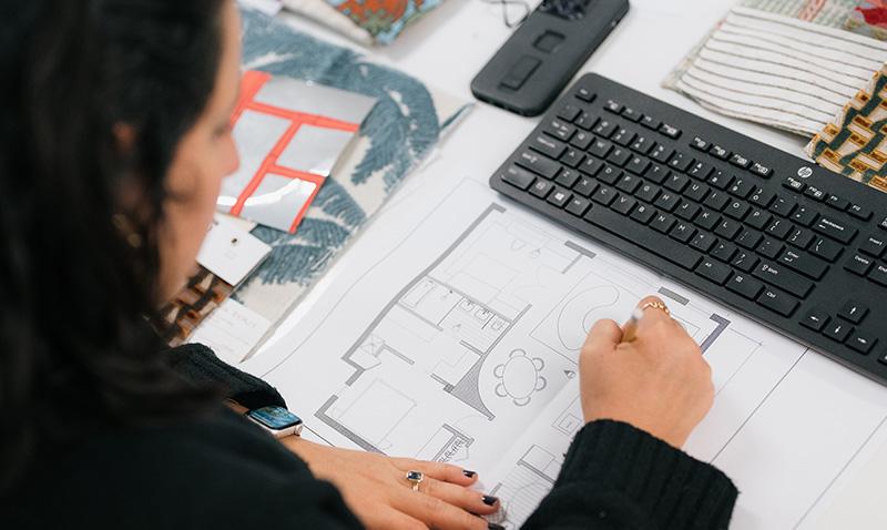 A NYSID Student sketches a floor layout plan in a design studio.